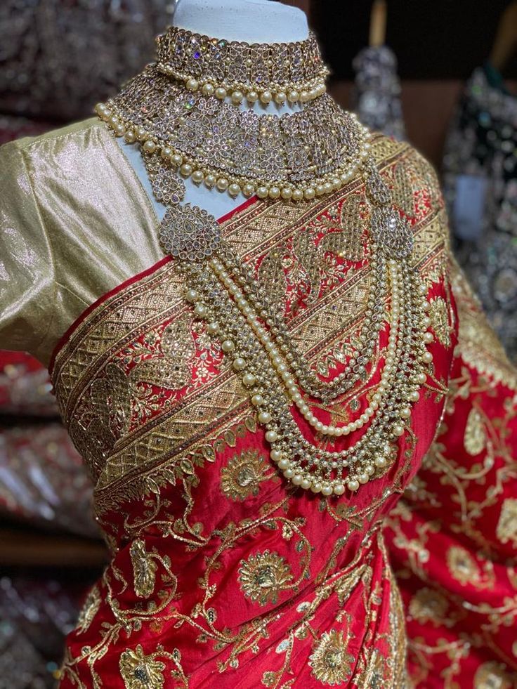 Bright red pink banarasi saree brilliantly crafted motifs in woven, stone and zardosi with zari weaved border and pallu around the drape captivates one towards it. The saree has an unstitched blouse and a net dupatta perfect edit to your wedding rituals. Beautifully teamed with traditional pearl bridal jewelry set is perfect for wedding. Fabric: Pure Silk Occasion: Wedding Ceremony or Reception. WASH CARE INSTRUCTIONS - Please Dry clean only when it is applicable. Slight color variation is possi Traditional Pre-draped Saree With Meenakari For Ceremonies, Ceremonial Pre-draped Saree With Cutdana, Gold Choli With Dupatta For Traditional Ceremonies, Traditional Gold Pre-draped Saree With Motifs, Elegant Gold Choli For Traditional Ceremonies, Gold Silk Thread Choli In Traditional Style, Gold Silk Thread Lehenga With Traditional Drape, Gold Lehenga With Silk Thread In Traditional Drape, Traditional Gold Silk Thread Choli