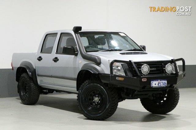 a white pick up truck is parked in a room with grey walls and black rims