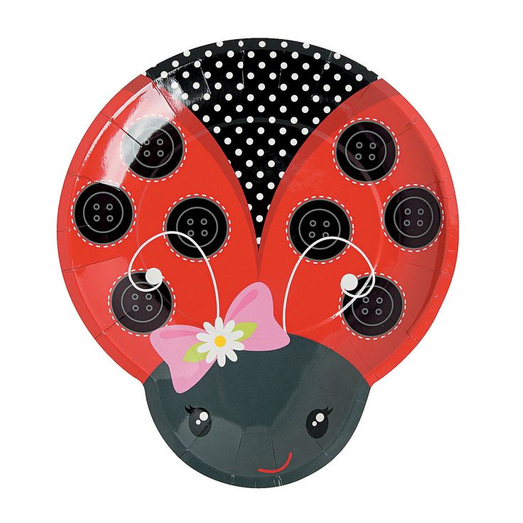 a ladybug paper plate with black dots and a pink bow on the front