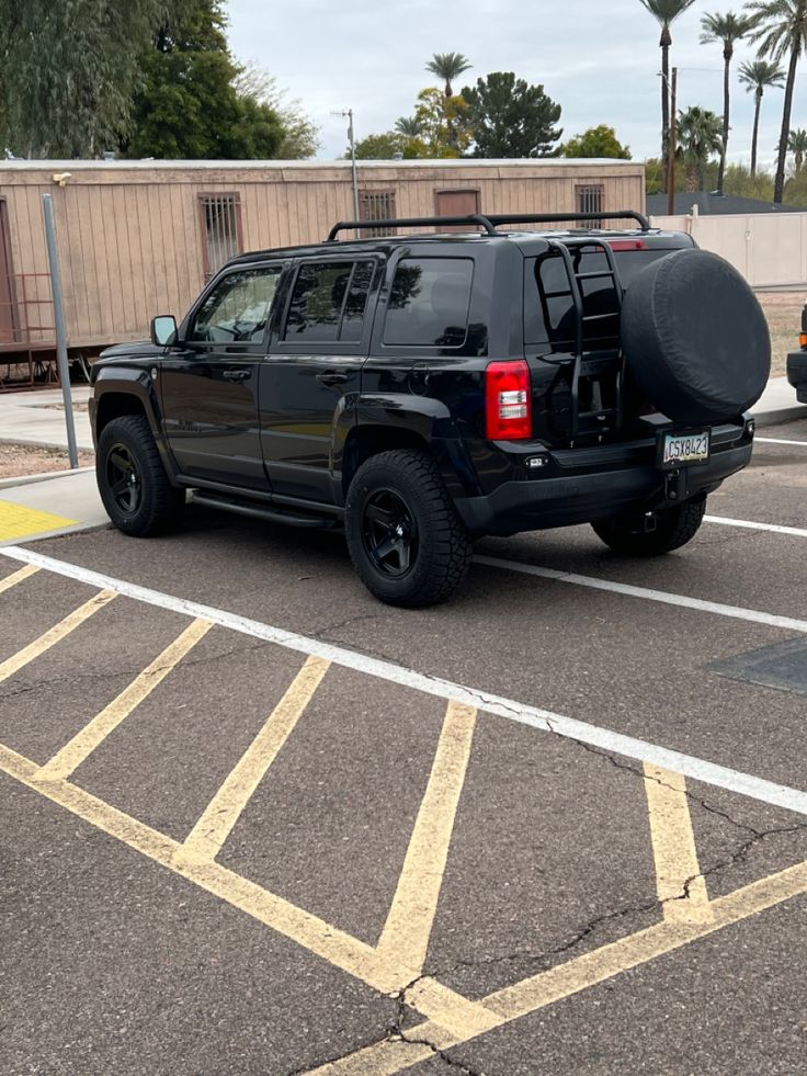 a black jeep parked in a parking lot