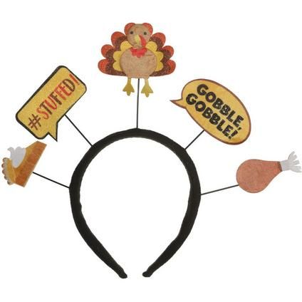 a black headband with turkeys and goodie signs on the front, along with other thanksgiving decorations