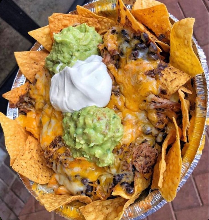 a plate filled with nachos and tortilla chips