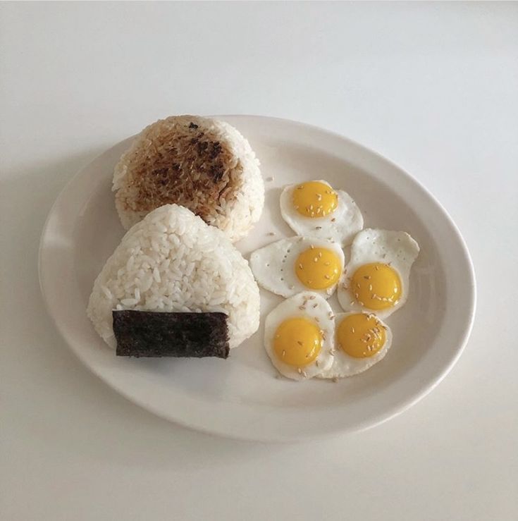 a white plate topped with eggs and rice