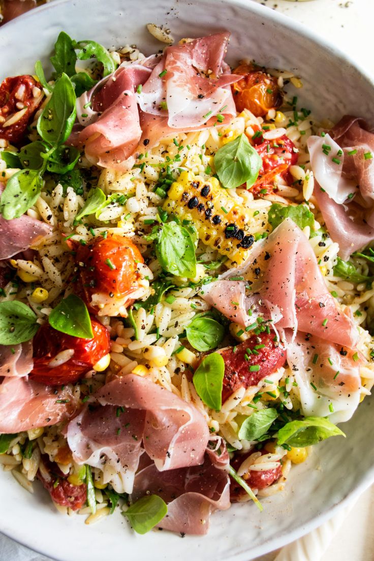 a white bowl filled with lots of different types of food