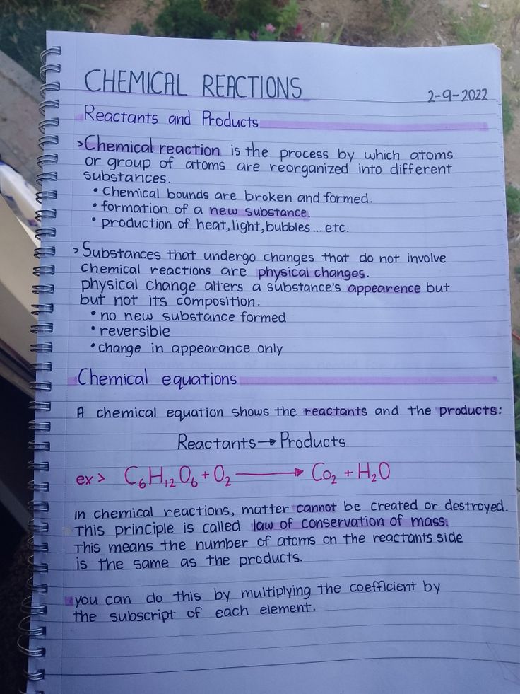 a notebook with chemical reactions written on it