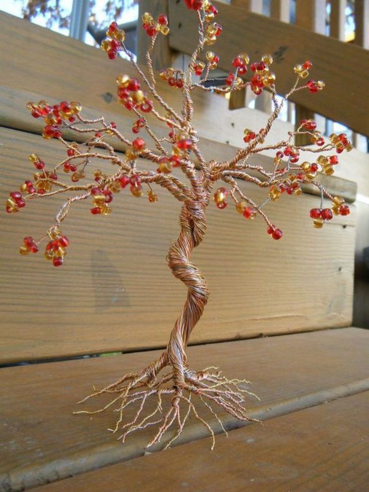 a wire tree with red and yellow beads on it