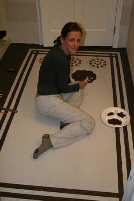 a woman sitting on the floor with some cake