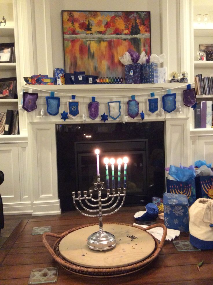 a hanukkah menorah sitting in front of a fireplace