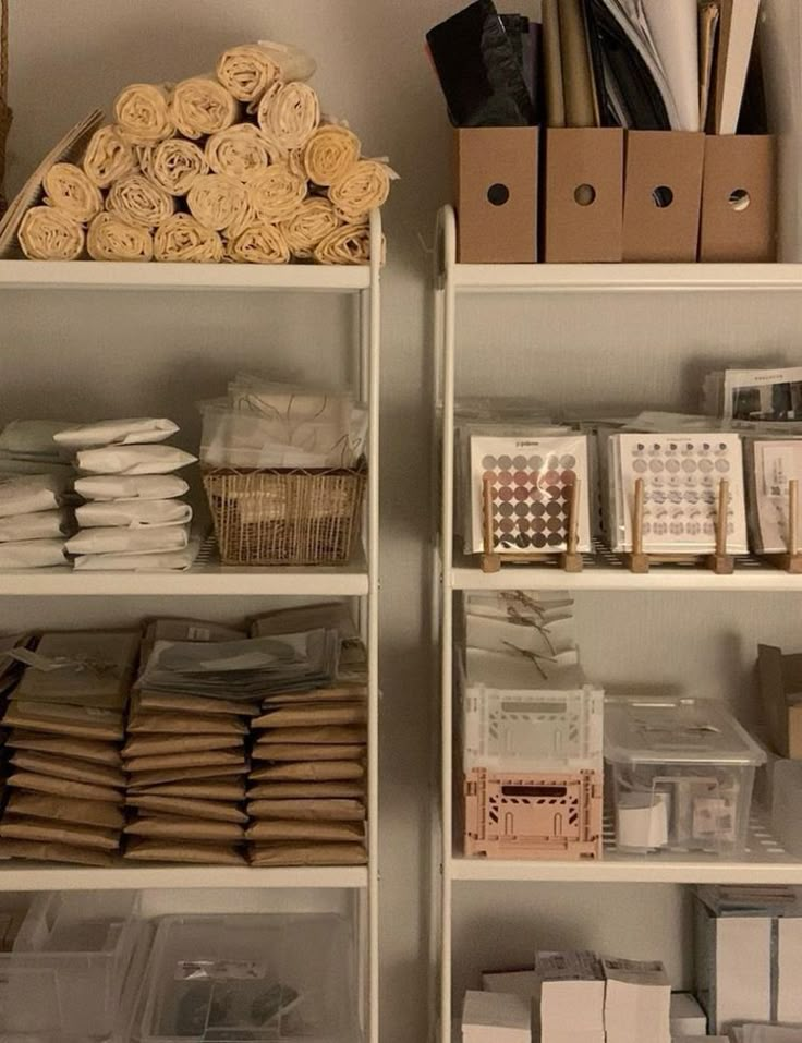 the shelves are filled with boxes, papers and other crafting supplies for sale on them