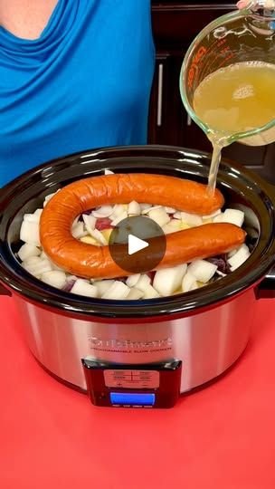 a woman pouring liquid into a slow cooker with hot dogs and onions in it