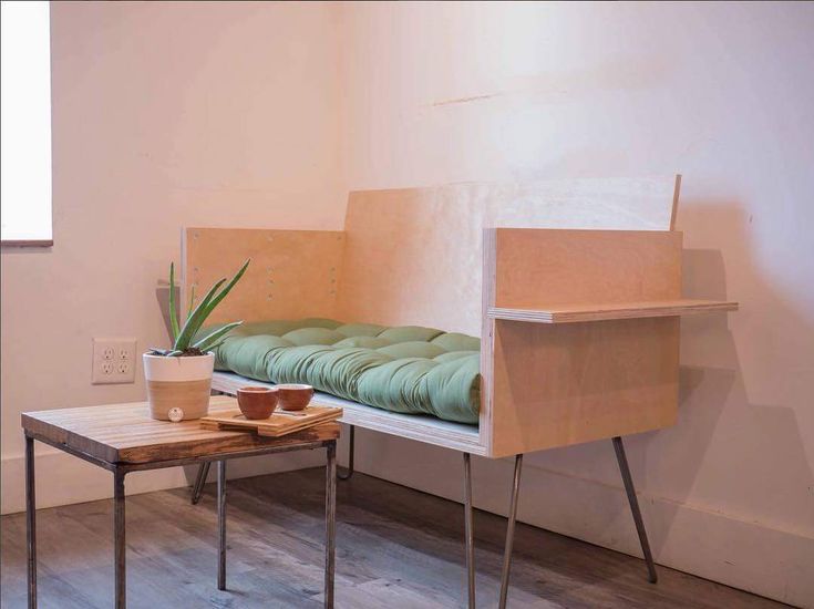 there is a bench that has been made out of plywood and some potted plants