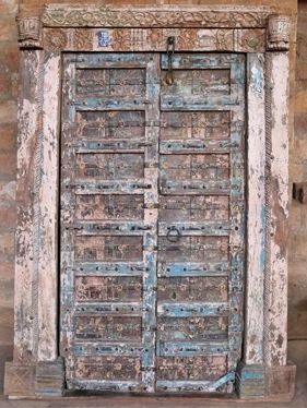 an old wooden door with peeling paint on it