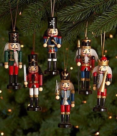 nutcracker ornaments hanging from a christmas tree