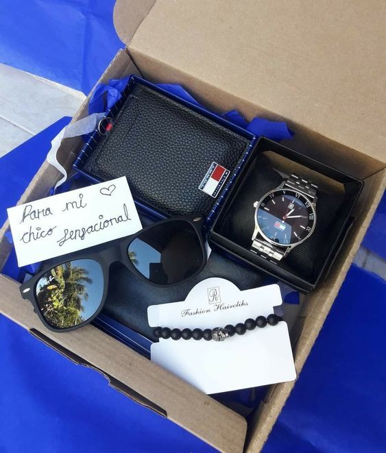 an open box containing a watch and other items