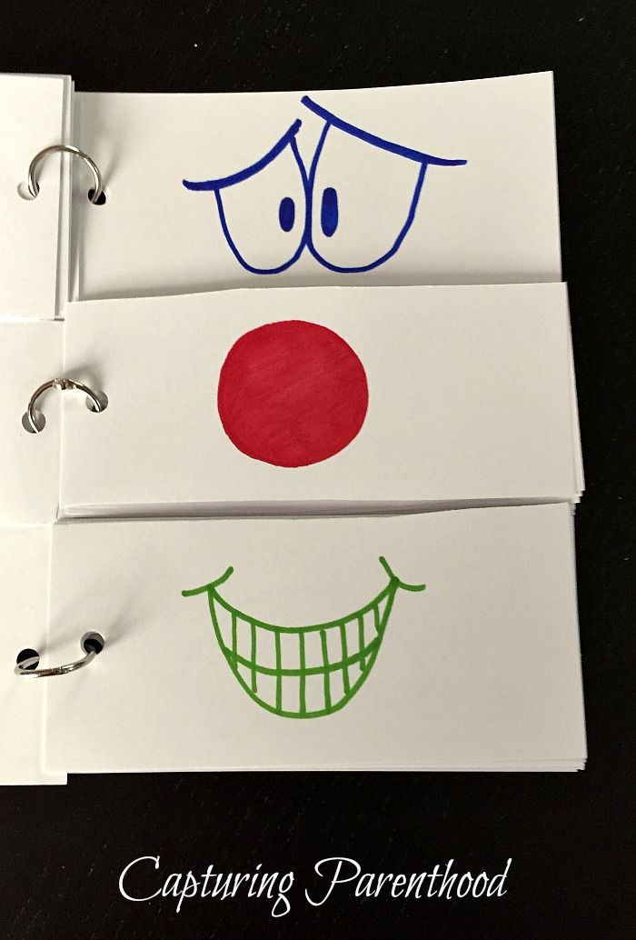 three notebooks with faces drawn on them