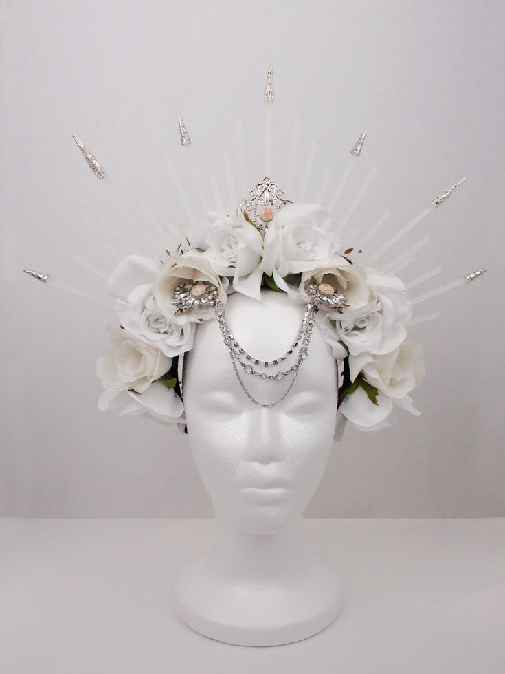 Gothic headdress fit to adorn any extravagant outfit. This ethereal piece is sure to attract attention to it wherever it may go! Though beautiful, this piece is also quite fragile, so please treat it with care. Unique Festival Headpiece With Tall Crown, Elegant Tall Crown Headpieces For Costume Party, Unique Tall Crown Headpiece For Festival, Elegant Structured Crown Headpiece For Festivals, Bohemian Pinched Crown Headpiece For Parties, Bohemian Headpieces With Pinched Crown For Party, Bohemian Crown Costume Hat For Weddings, Bohemian Wedding Crown Costume Hat, White Tall Crown Headpiece For Parties