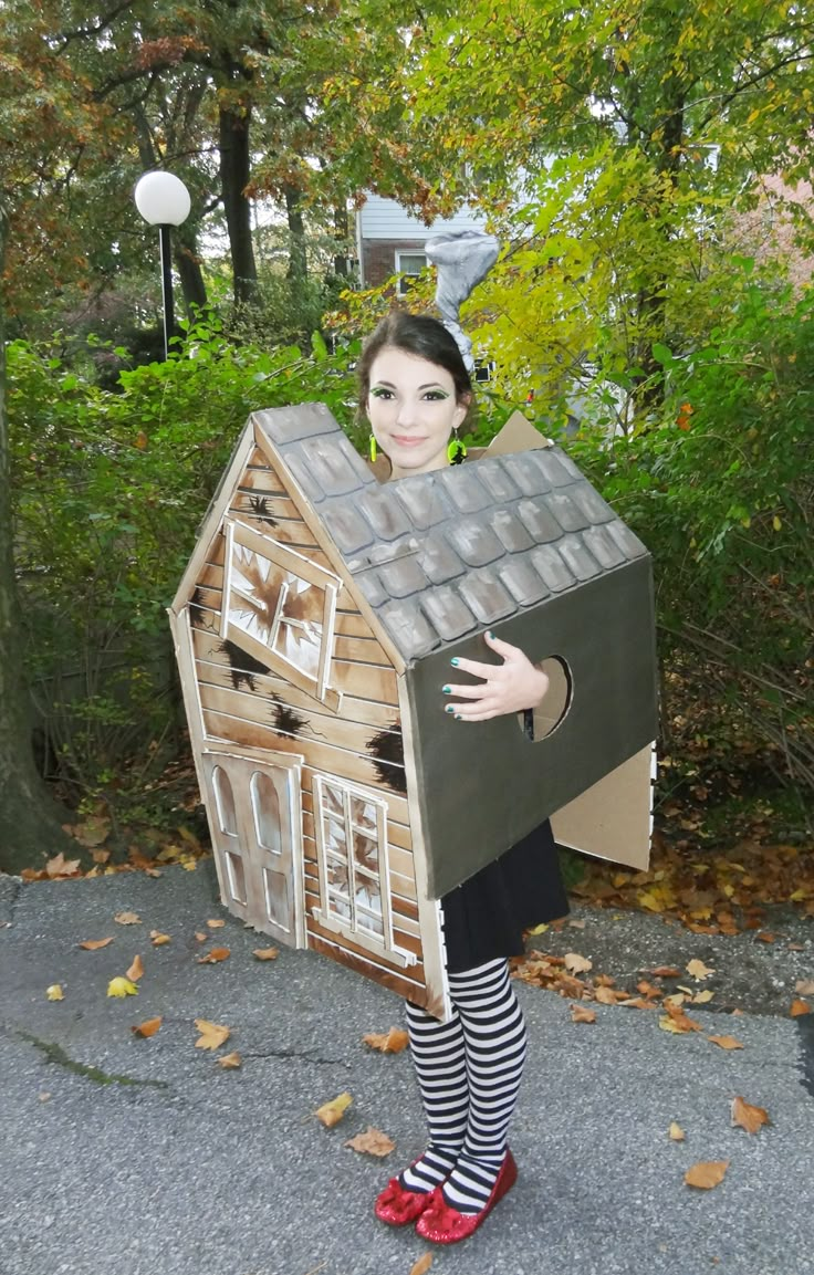 a woman is dressed up as a doll house