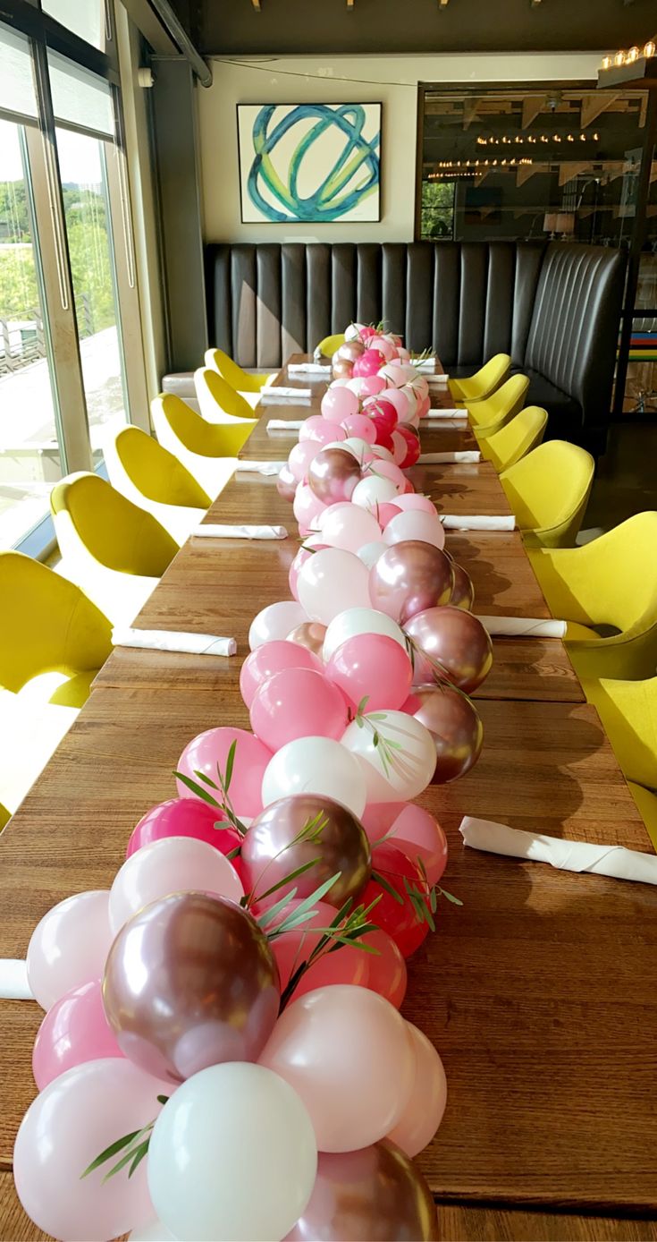 a long table with many balloons on it