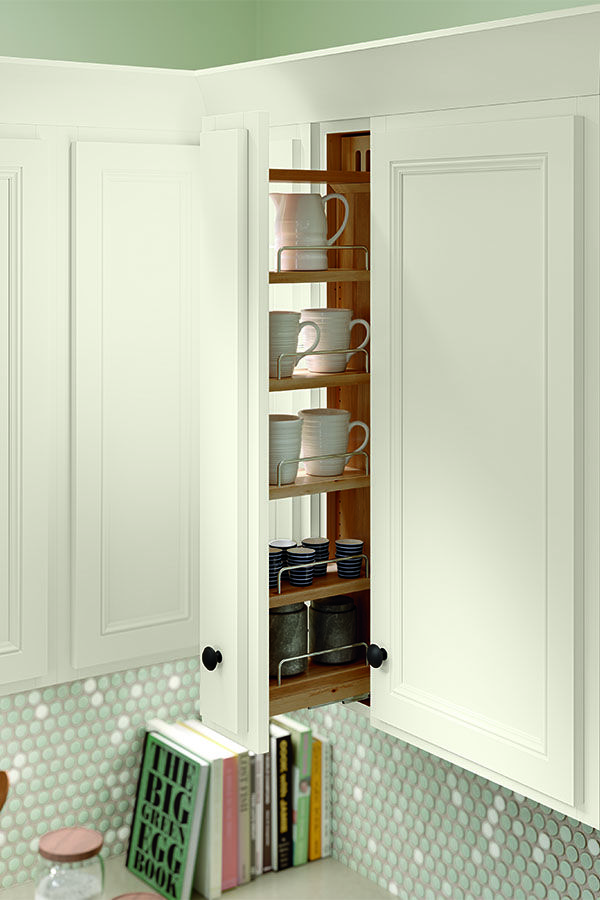 a kitchen with white cabinets and shelves filled with dishes