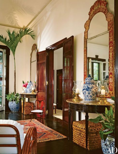 a living room filled with lots of furniture and vases on top of a table