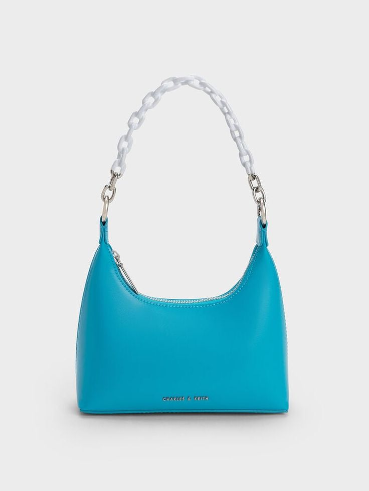 Add a pop of colour to your outfit with the Koi shoulder bag in brilliant ocean blue. With a chic silhouette that is equal parts slouchy and structured, this bag also opens up into a roomy interior with more than enough space to hold all your daily essentials. It also has a visually striking two-toned chain handle, which adds a touch of edgy cool to this stylish accessory. Carry yours as is, or clip on the detachable strap and turn it into a crossbody bag when you want to go hands-free. Blue Koi, Leather Bag Design, African Print Maxi Skirt, Eyewear Chain, Blue Handbag, Wallet Pouch, Charles Keith, Amethyst Purple, Daily Essentials