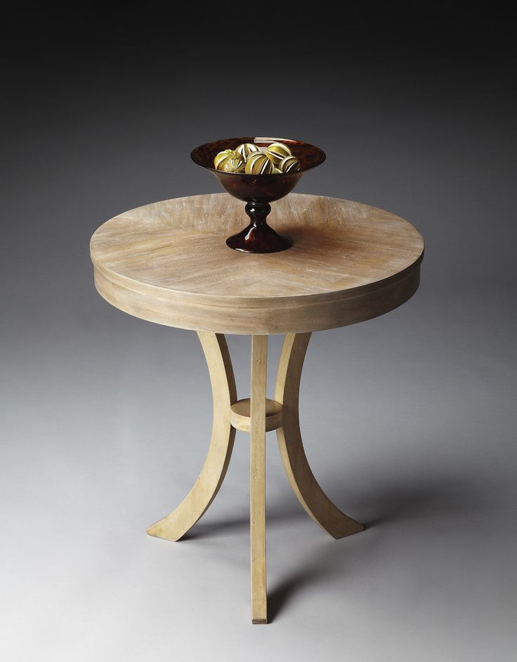 a small wooden table with a bowl on it's top and one leg in the middle