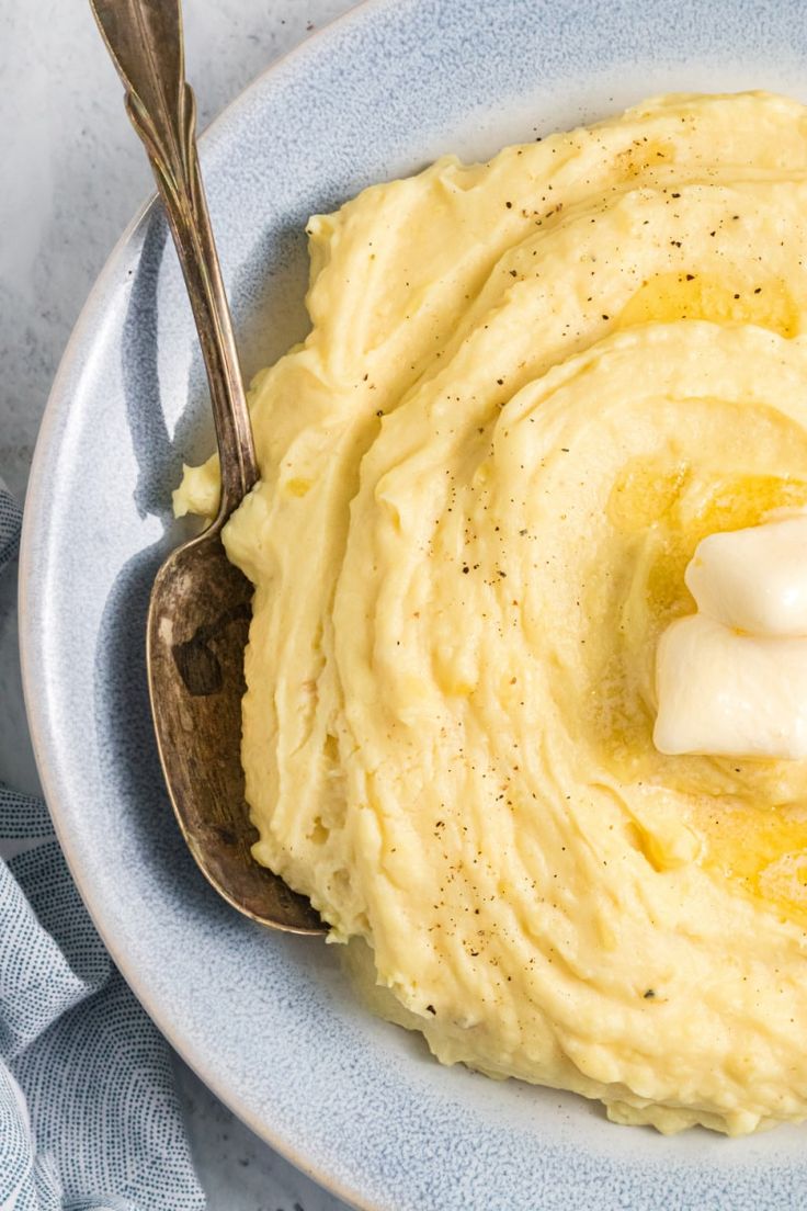 mashed potatoes in a bowl with a spoon on the side that says mustardd mashed potatoes