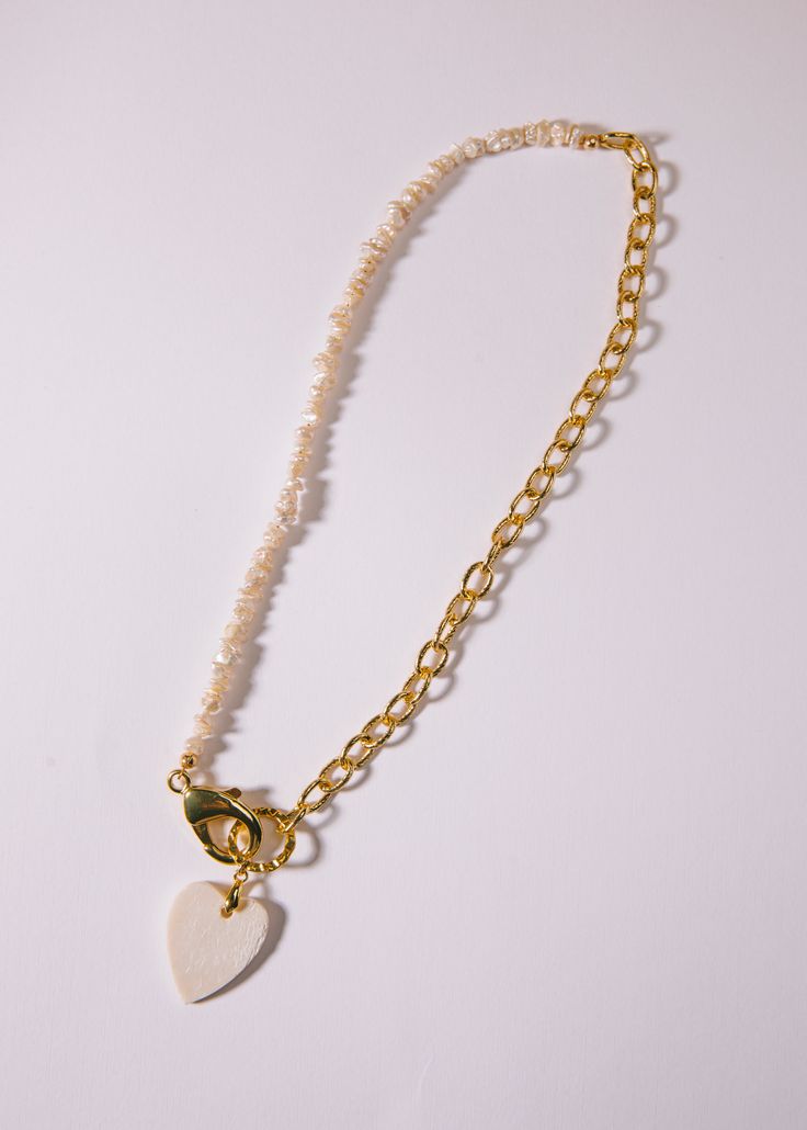 Multi-chain freshwater pearls and gold chain links, with a dangling white heart charm. 16" length and gold-filled. Gold Heart Shaped Pearl Chain Necklace, Luxury Gold Heart Beads Necklace, Gold-tone Heart Charm Chain Necklace, Elegant 14k Gold-filled Heart Charm Necklaces, Gold-tone Heart Necklace With Adjustable Chain, Heart-shaped Gold-tone Charm Necklace With Adjustable Chain, White Heart, Girl Gang, Chain Link