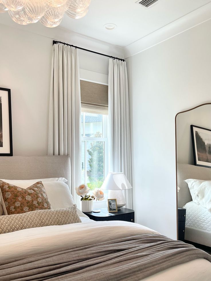 a bedroom with a large bed and white walls