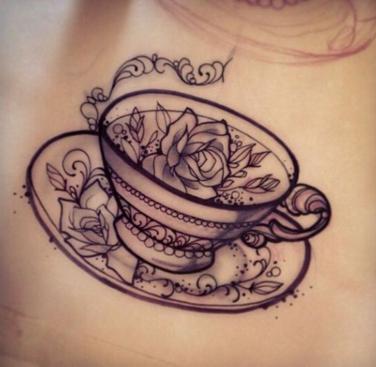 a woman's stomach with a tattoo on it that has a cup and saucer