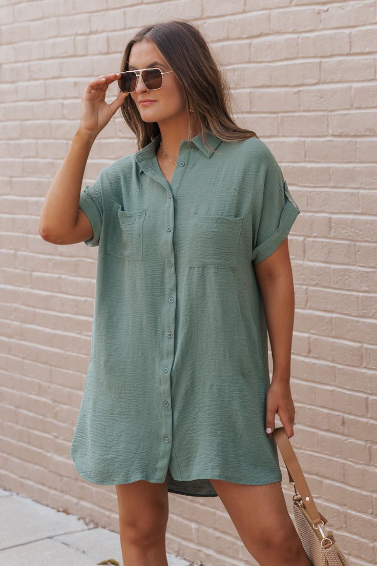 This Green Shirt Dress is a stylish and versatile piece perfect for casual occasions! Made from 100% polyester, this dress offers a comfortable fit with a smooth, lightweight feel. The button-up front and drop shoulder design add a modern touch to a classic silhouette, while the side pockets enhance functionality. Style it with flat sandals, a crossbody, and simple jewelry for a relaxed, everyday look. Casual Button-up Shirt Dress With Rolled Sleeves, Casual Collared Shirt Dress In Solid Color, Casual Collared Solid Color Shirt Dress, Solid Color Button-up Shirt Dress For Beach, Button-up Shirt Dress For Beach In Solid Color, Button-up Shirt Dress In Solid Color For Beach, Button-up Solid Color Shirt Dress For Beach, Collared Solid Color Shirt Dress For Beach, Collared Shirt Dress For Beach