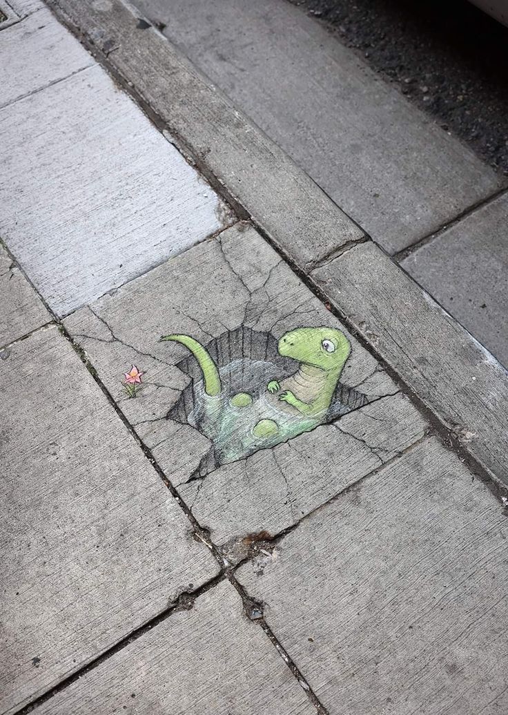 a drawing of a dinosaur on the sidewalk