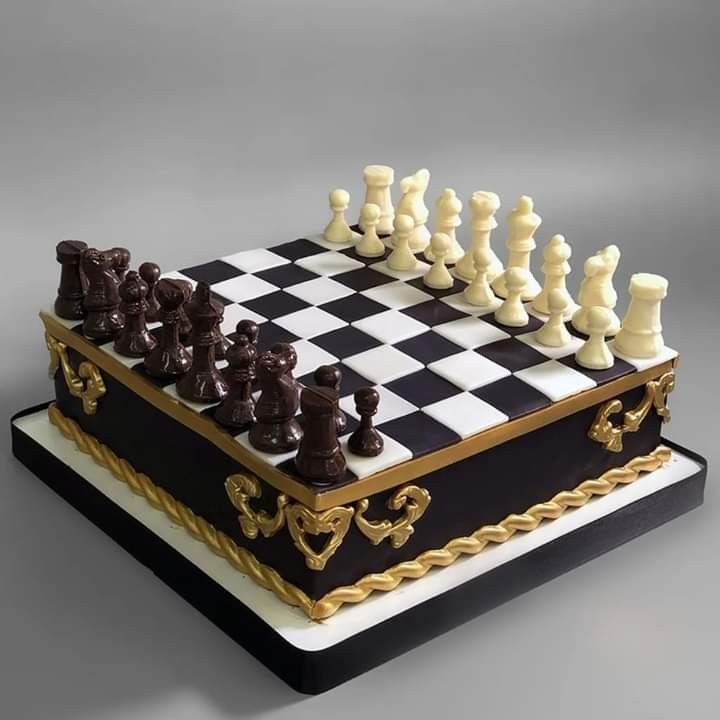 a cake shaped like a chess board and pieces