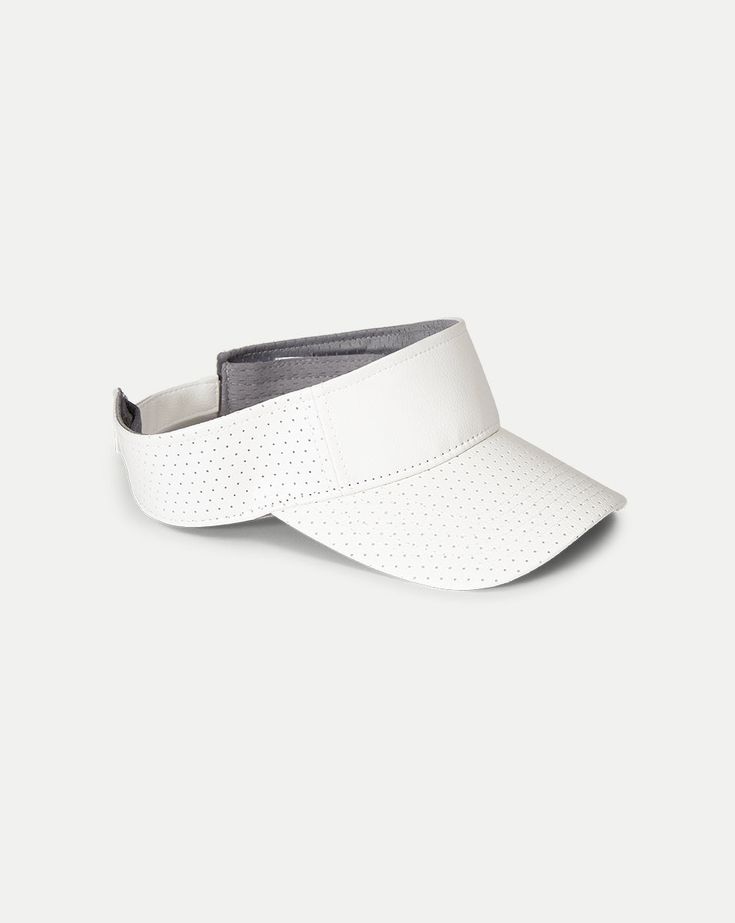 Made from vegan leather, this sporty visor features a perforated design for ventilation and an adjustable closure for a custom fit. Great for keeping distractions at a minimum during play, it's equally chic off the court. Part of our tennis capsule in collaboration with activewear brand L’Etoile Sport.100% Polyester Velcro closure Brim: 2 3⁄4" Spot clean Style #V002-1