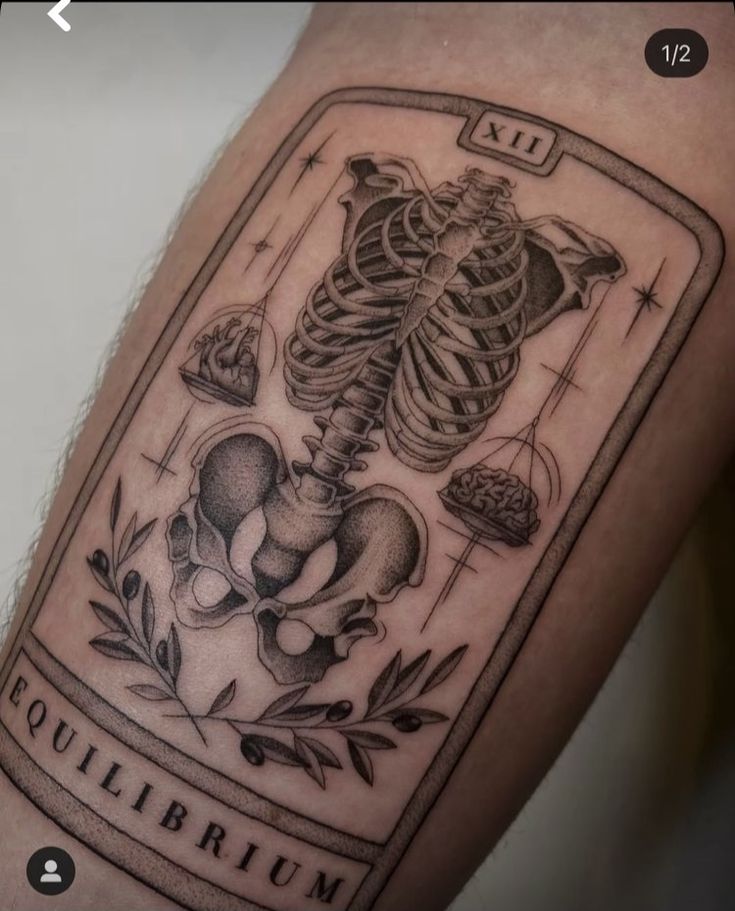 a tattoo with an image of a skeleton holding a heart and bones on it's arm