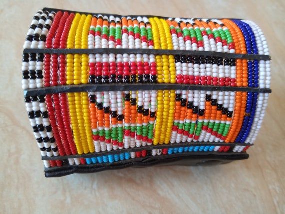 African Handcuff Beaded Bracelet, Maasai Bracelet, Zulu bracelet, Wrist bracelet, Cuff bracelet, Tribal bracelet, Boho braceletThis stylish beaded maasai bracelet is made using fine beads.The bracelet can be worn in almost all occasions.Color - multi-color.It has leather finish with 3 buttons for closure.Available in two sizes:medium and large3-5 days delivery via DHL ExpressThe shipping fee is for the first item only and additional  items ship for free.Wholesale available at a fair price,please Handmade Multicolor Cuff Bracelet For Festivals, Traditional Multicolor Handmade Cuff Bracelet, Adjustable Multicolor Traditional Cuff Bracelet, Traditional Multicolor Adjustable Cuff Bracelet, Multicolor Cuff Bracelet For Festivals And Gifts, Multicolor Cuff Bracelet As Gift For Festivals, Traditional Multicolor Beaded Bangle Bracelets, Traditional Multicolor Cuff Bracelet As Gift, Handmade Multicolor Wristband