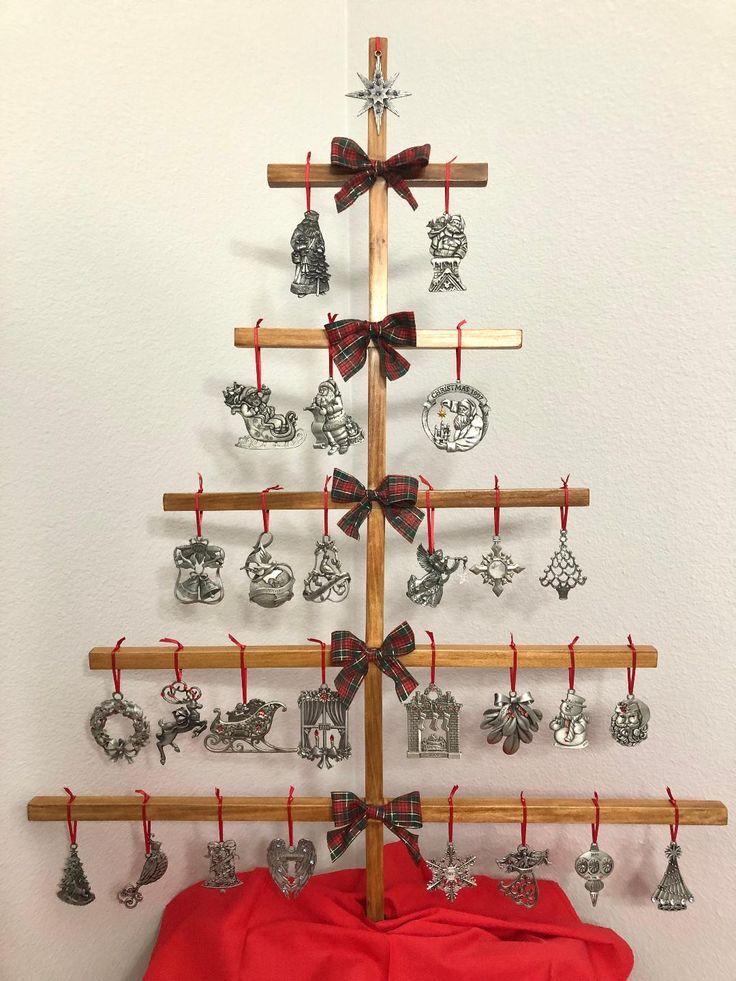 a wooden christmas tree with ornaments hanging from it