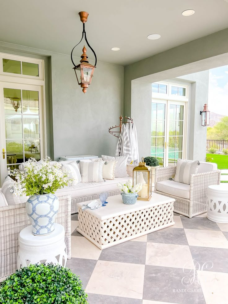 a living room filled with lots of white furniture