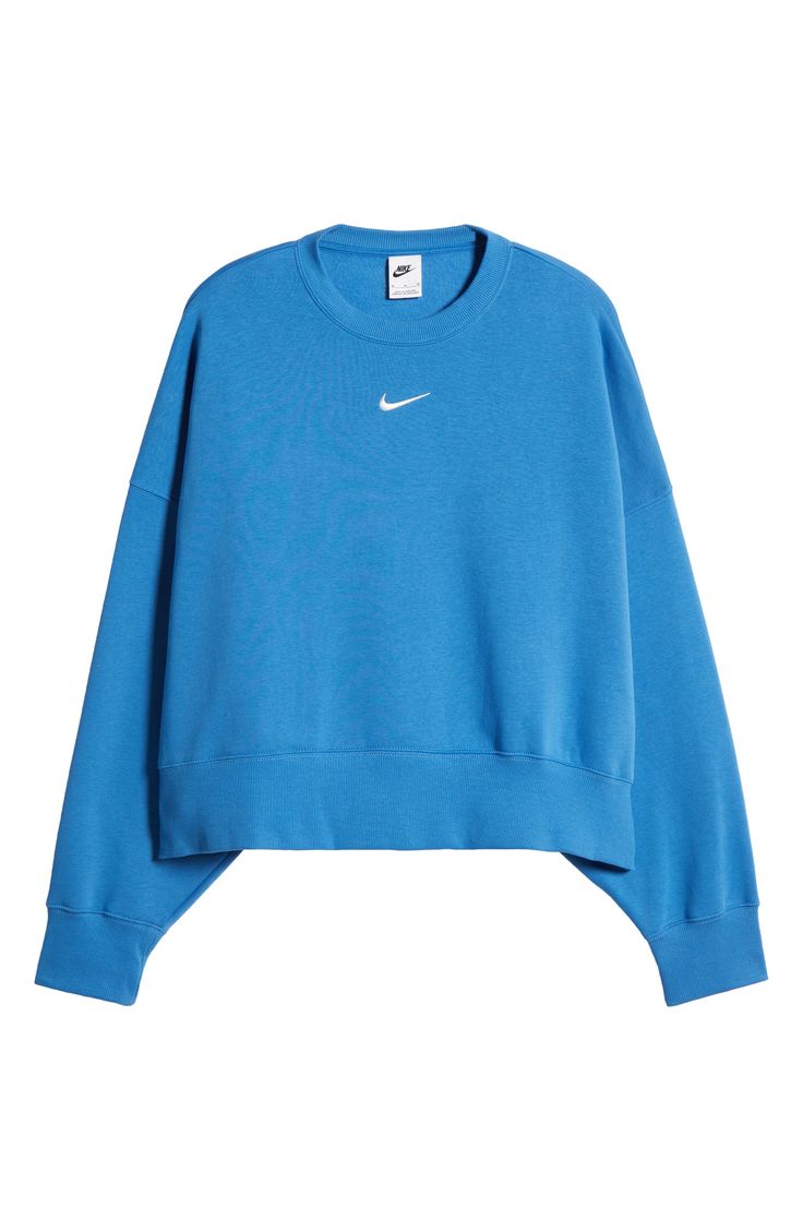 An embroidered Swoosh adds minimal branding to this cozy fleece sweatshirt cut for a relaxed, oversized fit that's enhanced by the dropped shoulders. 22" length (size Medium) Crewneck 80% cotton, 20% polyester Machine wash, tumble dry Imported Preppy Nike Sweatshirt, Cute Crew Neck Sweatshirts, Preppy Clothes For School, Tn Sweatshirt, Crew Neck Sweatshirt Aesthetic, Nike Sweatshirt Outfit, Popular Sweatshirts, Lulu Sweatshirt, Blue Sweatshirt Outfit