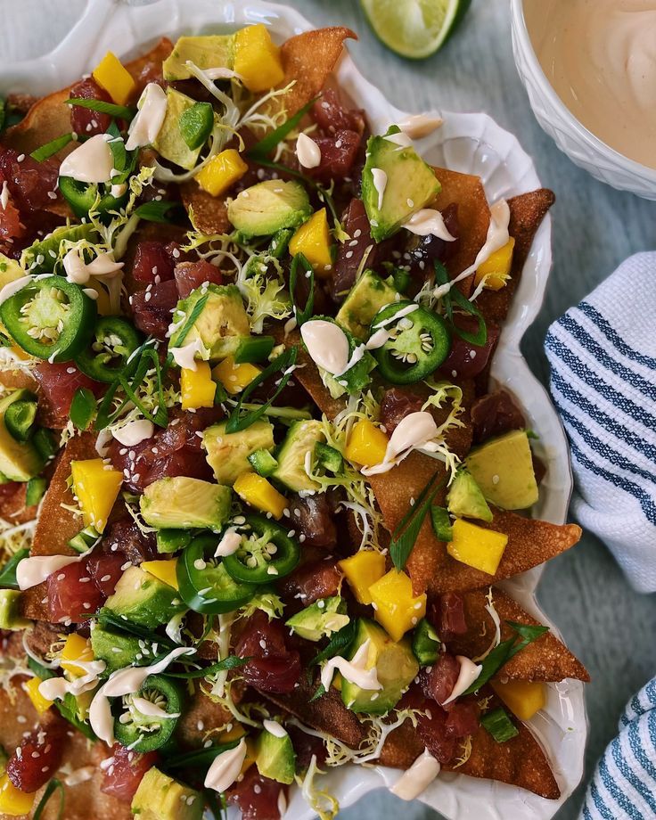 a plate filled with nachos topped with toppings