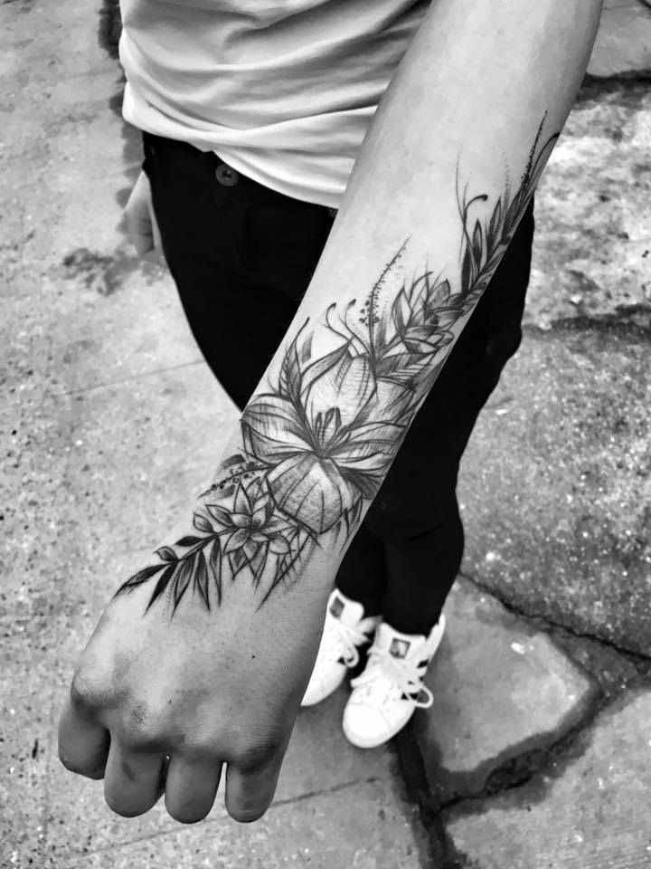 a person with a flower tattoo on their arm