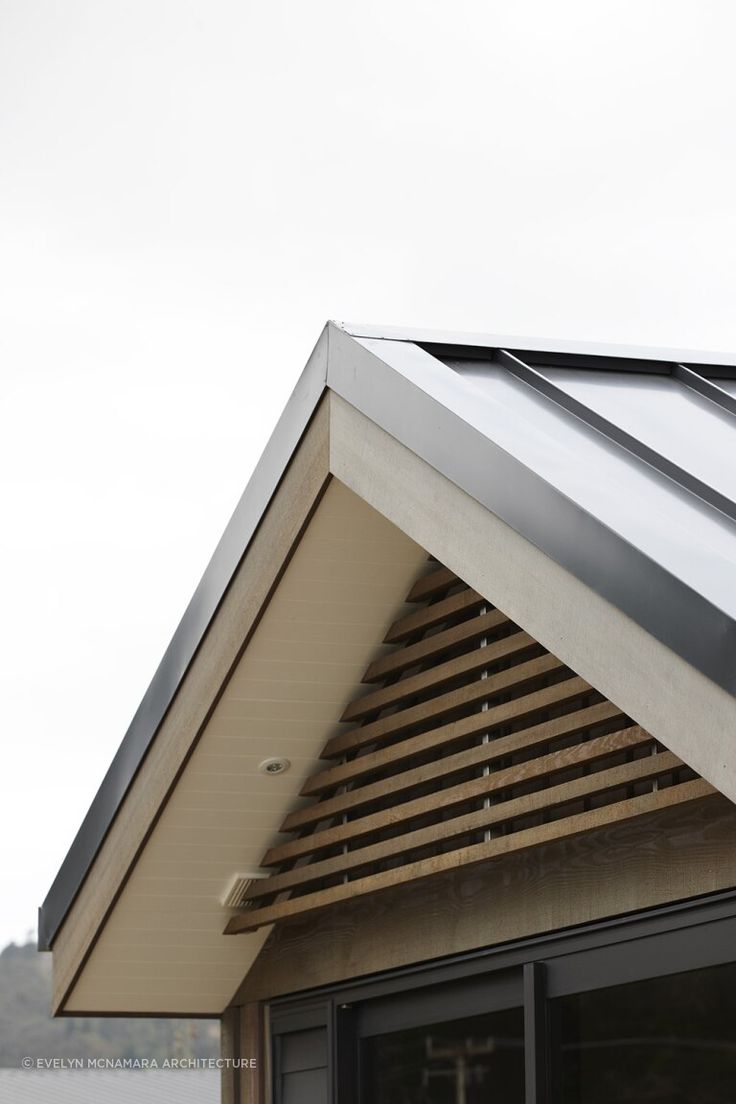 the roof of a building with a metal gutter