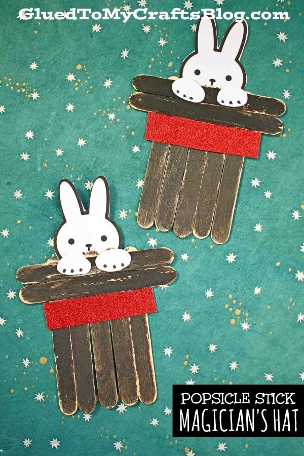 popsicle sticks are decorated to look like rabbits in a magician's hat with stars on the background