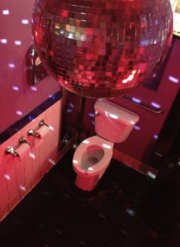 a bathroom with a disco ball above the toilet