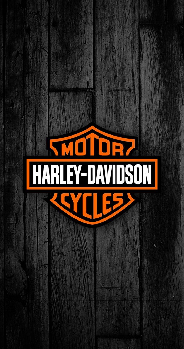 an orange harley davidson logo on a wooden wall with the words motor cycles written in it