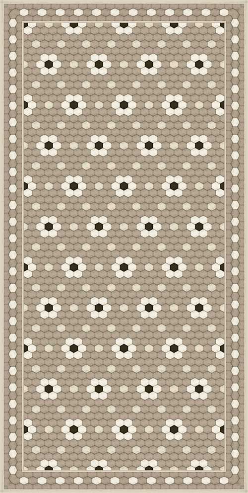 an area rug with black and white flowers on the border, in front of a beige background