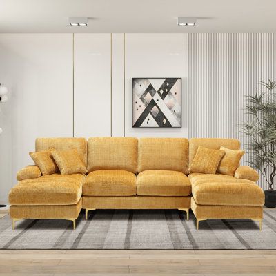 a living room with a yellow couch and rug