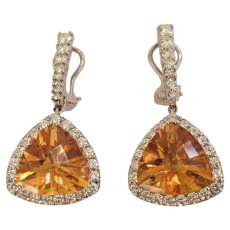 18kt White Gold hanging earrings with triangular cushion cut orange citrine surrounded by approximately 4.50cts of White Diamonds. The citrine is approximately 3/4" tall and 1" wide. The earrings measures 2" long from top to bottom. The earrings can be made for Clip or pierced ears. The Earrings can be made with any color stone you select. Please contact me with any inquiries you may have. Best, Christina Long Hanging Earrings, Gold Hanging Earrings, Cushion Cut Earrings, Orange Diamond, Earrings Multiple, Cut Orange, Gold And Orange, Orange Gem, Orange Jewelry