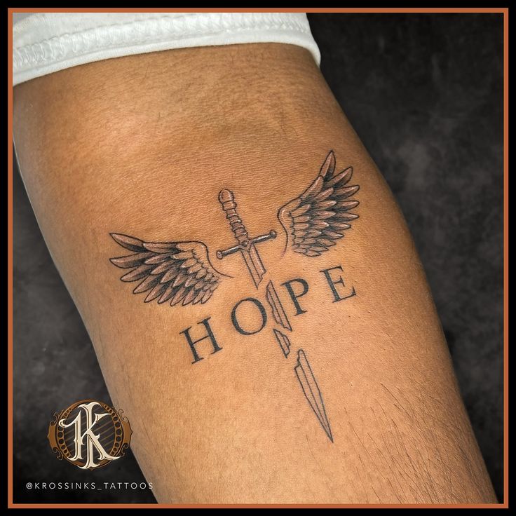 This tattoo design would carry deep meaning, with the broken sword showing past struggles, the wings indicating rising above, and hope as the unbreakable force tying it all together. . . Artist @kewal_patil92 Tattoo done at @krossinks_tattoos . . #krossinks_tattoos #tattooart #hope Swords With Wings Tattoo, Bulletproof Tattoo Ideas, Meaningful Tattoo Sleeve Men, Cross Swords Tattoo Design, Tattoos Deep Meaning, Hope Tattoo Designs, Tattoo Ideas With Deep Meaning, King Of Kings Tattoo, Past Tattoo