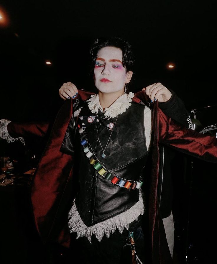 a man dressed up in costume and makeup